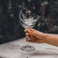 Broken crystal goblet in the hand of a woman Royalty Free Stock Photo