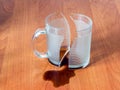 Broken cup and spilled coffee or tea in the office on the table Royalty Free Stock Photo