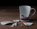 Broken cup on wooden background Royalty Free Stock Photo