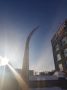 Broken curved barrier against the blue sky and the building