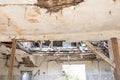 Broken damaged and collapsed ceiling and roof of old house abandoned after aftermath disaster and heavy rain leakage