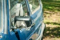 Broken and damaged side mirror on the old rusty car doors with remaining wires and duct tape holding plastic frame without glass Royalty Free Stock Photo