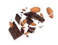 Broken dark chocolate bar with whole and crushed almonds in the air on white background Royalty Free Stock Photo