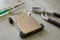 Broken and Destroyed Hard Drive Disk and Tools on Wooden Table Royalty Free Stock Photo