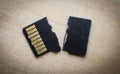 Broken destroyed micro sd card on white surface Royalty Free Stock Photo