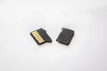 Broken destroyed micro sd card on white surface Royalty Free Stock Photo