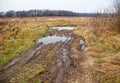 Broken dirt road in the field Royalty Free Stock Photo