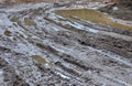 Broken dirt road after heavy rain. Swampy lagoon of a road demonstrates the most common problem in maintaining rural roads Royalty Free Stock Photo