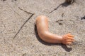 Broken doll hand in the sand Royalty Free Stock Photo