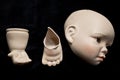 Broken Doll Parts on Black Background Royalty Free Stock Photo