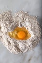 Broken egg on flour on marble background Royalty Free Stock Photo