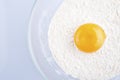 Broken egg on flour, means for making bread Royalty Free Stock Photo