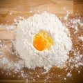 Broken egg on flour, means for making bread Royalty Free Stock Photo