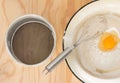 Broken egg in flour Royalty Free Stock Photo