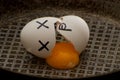 Broken egg in a frying pan with the leaked yolk, close-up