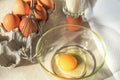 Broken egg in a glass bowl ready for whipping. Fresh chicken egg