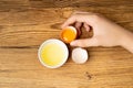 Broken Egg in Hand, Raw Yolk and White Separation, Cracked Brown Shell, Fresh Broken Organic Chicken Eggs Royalty Free Stock Photo