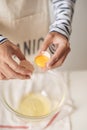 Broken egg in hands with separated yolk closeup