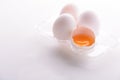 Broken egg with whole eggs in a transparent plastic container on white wooden background Royalty Free Stock Photo