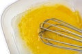 Broken eggs with sugar in a bowl and whisk top view Royalty Free Stock Photo