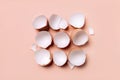 Broken eggshells in the middle of the light coral color background Royalty Free Stock Photo