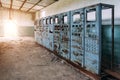 Broken electrical switchgear cabinets with control panels in abandoned factory