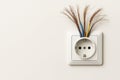 Broken electrical wires stick out of the socket. Space for text. Royalty Free Stock Photo