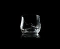 Broken empty whiskey glass isolated on black background Royalty Free Stock Photo