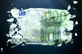 Broken Euro paper money on a green background