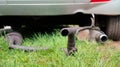 Broken exhaust and muffler of a car, rusted silencer fallen down on the road, breakdown of vehicle Royalty Free Stock Photo