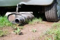 Broken exhaust and muffler of a car, rusted silencer fallen down on the road, breakdown of vehicle Royalty Free Stock Photo