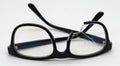 Broken eyeglasses with black frame isolated on white Royalty Free Stock Photo