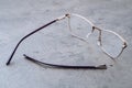 Broken eyeglasses lying on table in optical workshop Royalty Free Stock Photo