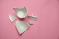 Broken fragments of a crack broken white cup. Royalty Free Stock Photo
