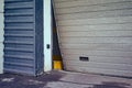 Broken garage for car exit, bent door close-up