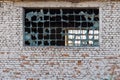 broken glass block window in white brick wall texture and background Royalty Free Stock Photo