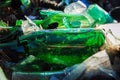 Broken glass bottles, landfill in the forest, pollution problem