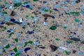 Broken glass bottles on white sand. Bottles is green and blue colour. Trash on the sand. Ecological problem Royalty Free Stock Photo