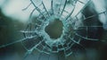 Broken glass with circular hole, sharp shards radiating outward