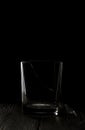 Broken glass goblet. Stands on black boards. Shot on a black background Royalty Free Stock Photo