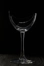 Broken glass goblet. Stands on black boards. Shot on a black background Royalty Free Stock Photo