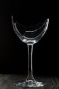 Broken glass goblet. Stands on black boards. Shot on a black background Royalty Free Stock Photo