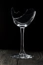 Broken glass goblet. Stands on black boards. Shot on a black background Royalty Free Stock Photo