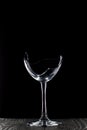 Broken glass goblet. Stands on black boards. Shot on a black background Royalty Free Stock Photo