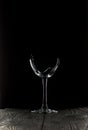 Broken glass goblet. Stands on black boards. Shot on a black background Royalty Free Stock Photo