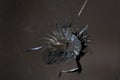 Broken glass. Hole, cracks in the window from the fragment of the projectile. Background, texture. A symbol of a broken life. How Royalty Free Stock Photo