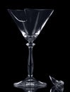 Broken glass martini fragment isolated on black background.