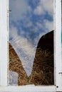 Broken glass in an old window of the hayloft Royalty Free Stock Photo