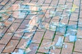 Broken glass. Shards of glass on the paving stones. The concept of destruction