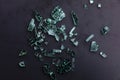 Broken glass with sharp Pieces over dark grey background. Destruction, danger. Royalty Free Stock Photo